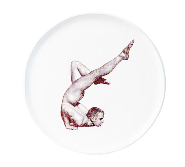 Photographic transfer of a shoulder stand with one leg extended on stoneware Gestures plate, J Schatz.