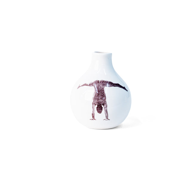 Photographic transfer of a handstand with legs split wide on porcelain Gestures bud vase, J Schatz.