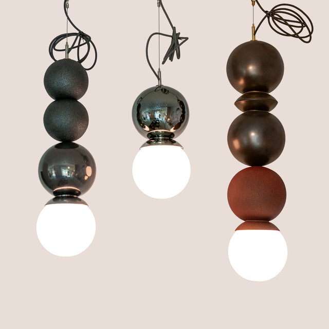 Metallic Edition Dot Dot Dot ceramic pendants in Graphite, Metallic Black, and Bronze, J Schatz.