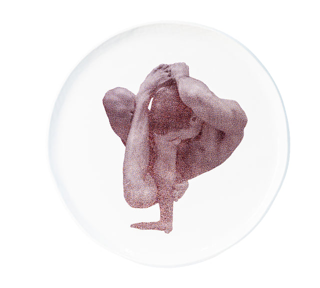 Photographic transfer of a one-arm balance with leg drawn back on stoneware Gestures plate, J Schatz.