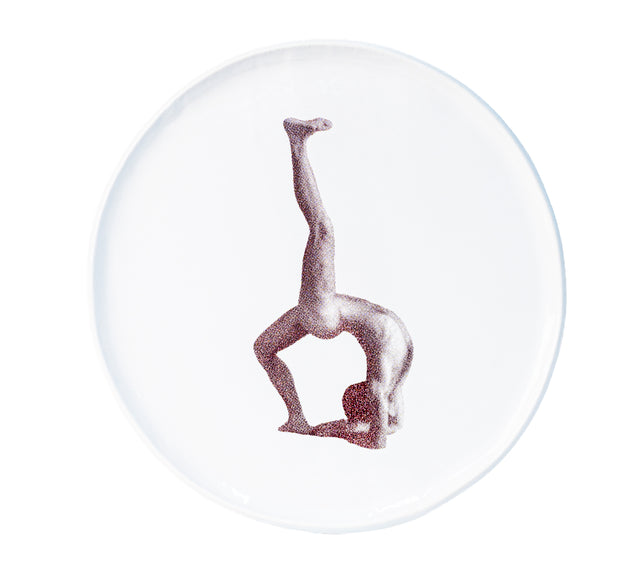 Photographic transfer of an inverted figure with one leg vertical on stoneware Gestures plate, J Schatz.