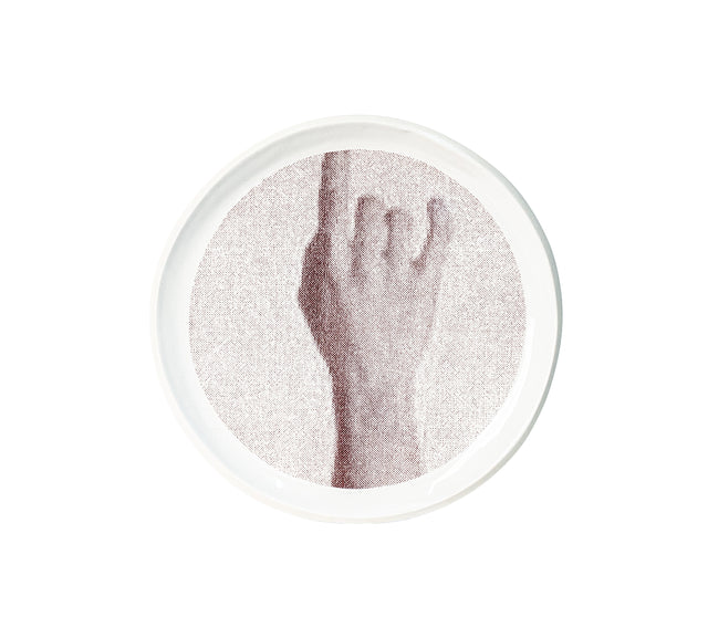 Photographic transfer of a raised forearm and open hand on stoneware Gestures plate, J Schatz.