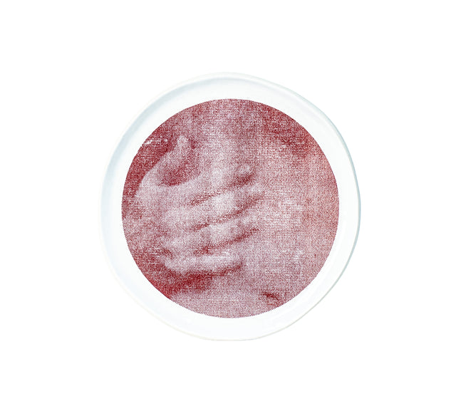 Photographic transfer of a hand gripping a shoulder on stoneware Gestures plate, J Schatz.