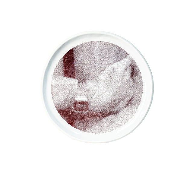 Photographic transfer of a hand resting at the waist on stoneware Gestures plate, J Schatz.