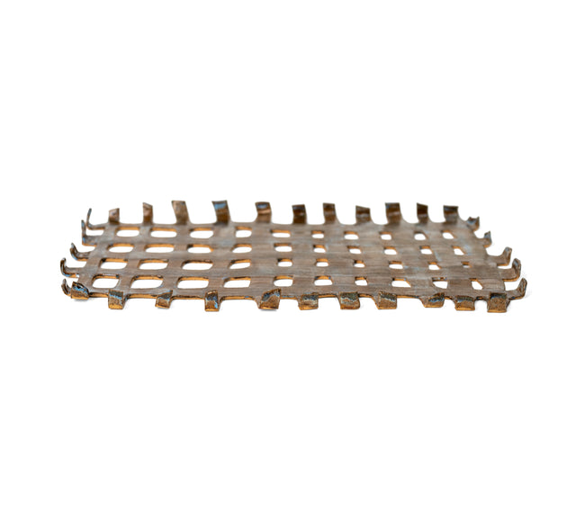 Woven stoneware tray from a low angle, bent strip ends along the edges in brown and pale blue glaze, by Peter Souza Jr., J Schatz