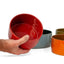 Sumac red ceramic Utilità bowl held to show the glossy interior, J Schatz.