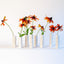 Group of white textured ceramic bud vases, J Schatz