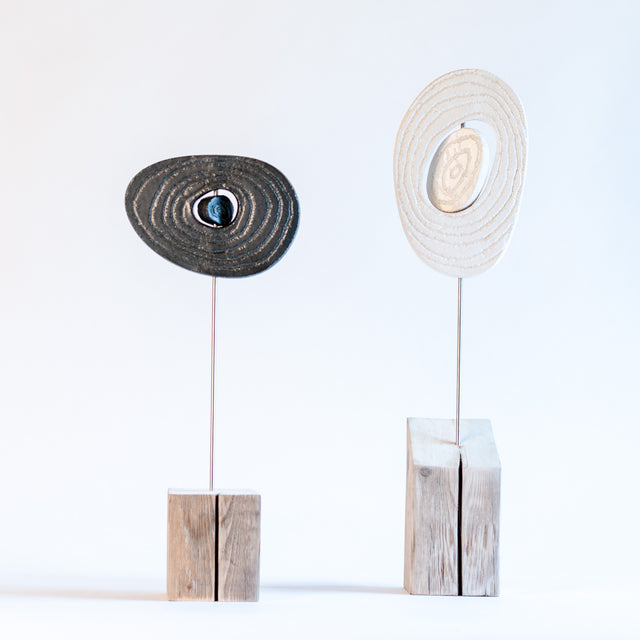 Zen sculptures, paired stoneware forms on carved wood bases, by Jim Schatz and Peter Souza Jr.
