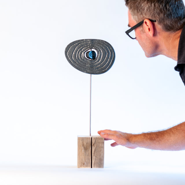 Zen sculpture, stoneware form on a carved wood base, by Jim Schatz and Peter Souza Jr.