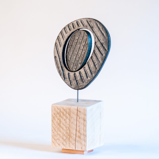 Zen sculpture, stoneware form on a carved wood base, by Jim Schatz and Peter Souza Jr.