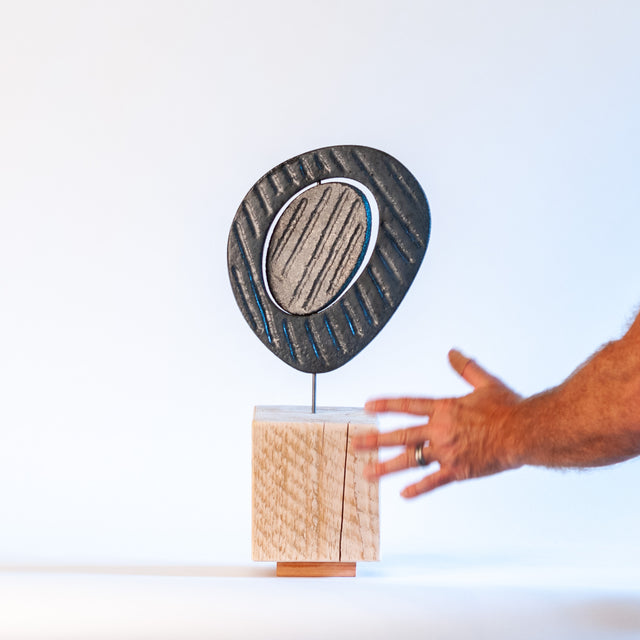 Zen sculpture, stoneware form on a carved wood base, by Jim Schatz and Peter Souza Jr.