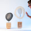 Zen sculptures, paired stoneware forms on carved wood bases, by Jim Schatz and Peter Souza Jr.