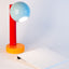 Spot On ceramic desk lamp in light aqua, sumac red, and orange peel, side view, J Schatz
