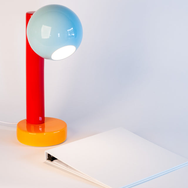 Spot On ceramic desk lamp in light aqua, sumac red, and orange peel, side view, J Schatz