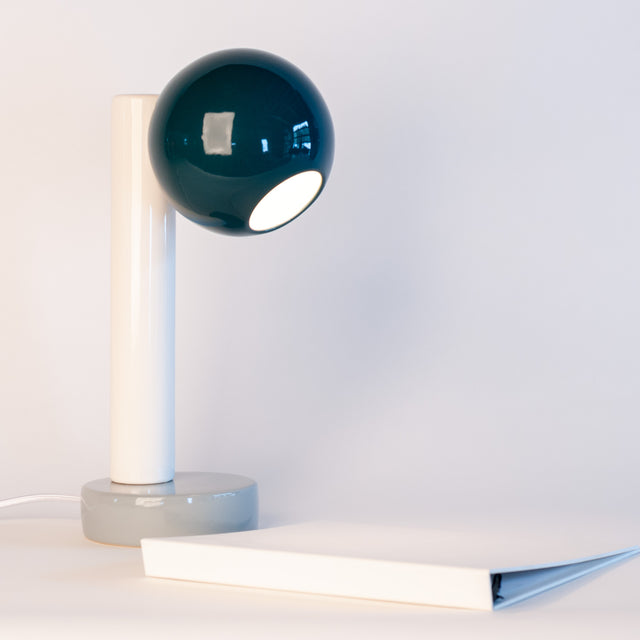 Spot On ceramic desk lamp in midnight blue, bright white, and slate grey, side view, J Schatz