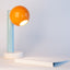 Spot On ceramic desk lamp in orange peel, light aqua, and bright white, side view, J Schatz