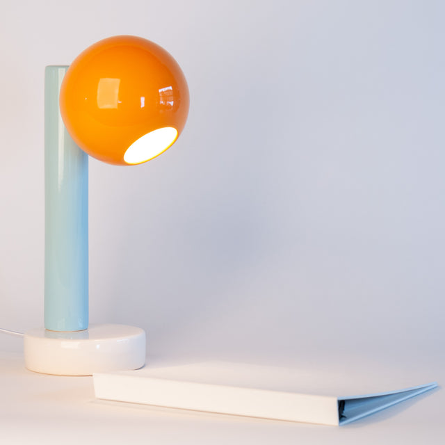 Spot On ceramic desk lamp in orange peel, light aqua, and bright white, side view, J Schatz