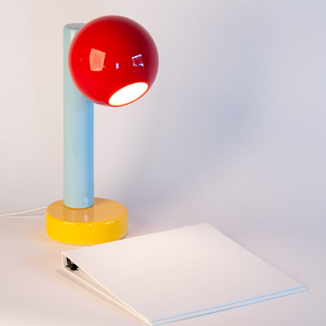Spot On ceramic desk lamp in sumac red, light aqua, and goldenrod yellow, side view, J Schatz