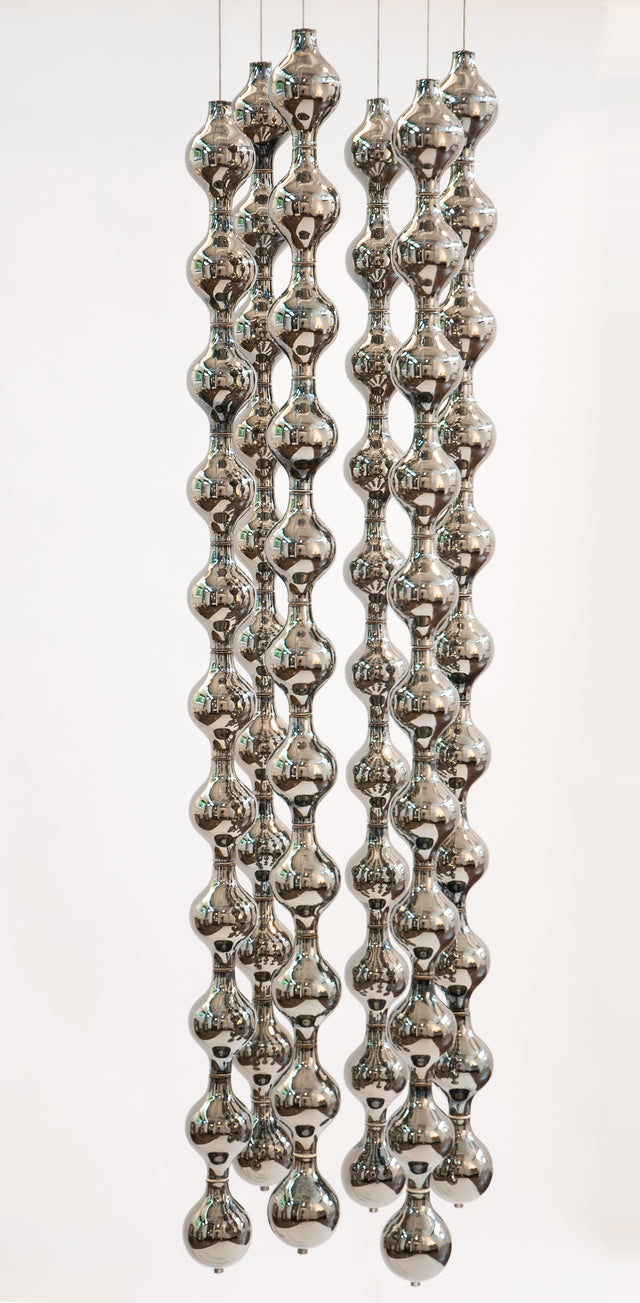 Happening Circle, suspended sculpture of platinum-glazed stoneware shapes on steel cables, by Jim Schatz
