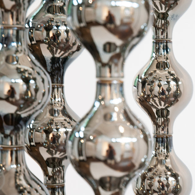Happening Circle, suspended platinum stoneware sculpture on six steel cables, by Jim Schatz