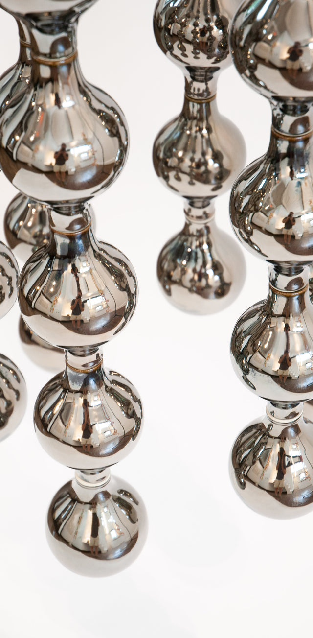 Happening Circle, detail of mirror-finished platinum stoneware shapes, by Jim Schatz