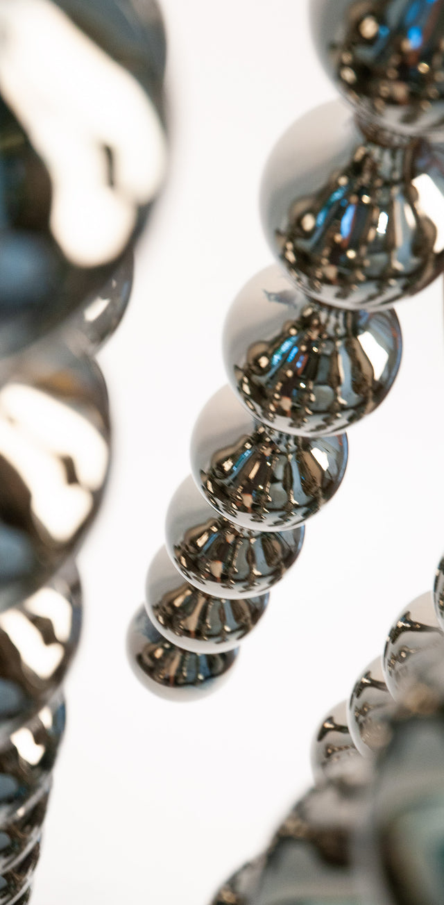 Happening Circle, detail of mirror-finished platinum stoneware shapes, by Jim Schatz