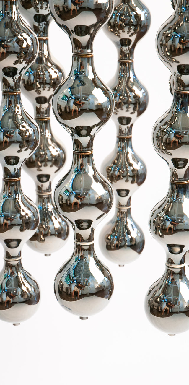 Happening Circle, detail of mirror-finished platinum stoneware shapes, by Jim Schatz