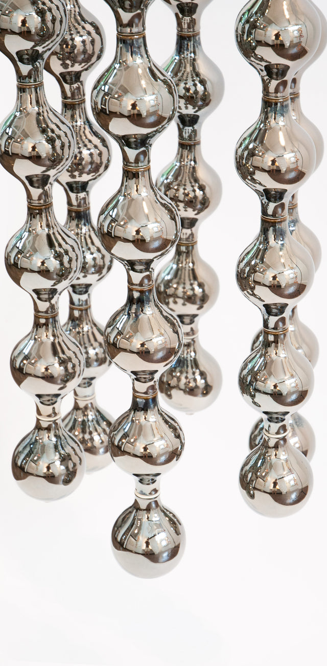 Happening Circle, detail of mirror-finished platinum stoneware shapes, by Jim Schatz