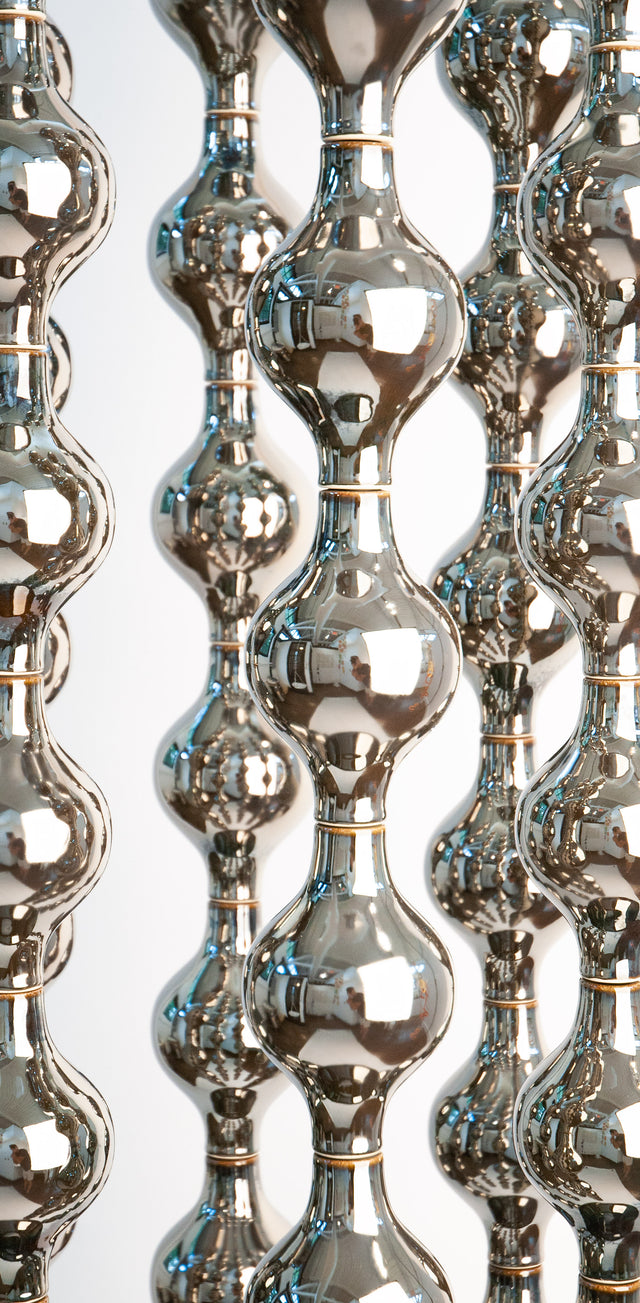 Happening Circle, detail of mirror-finished platinum stoneware shapes, by Jim Schatz