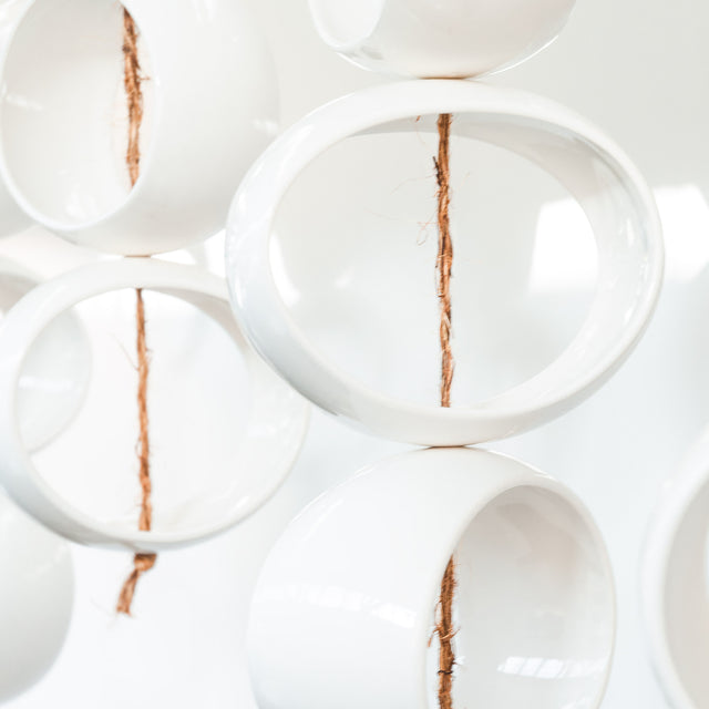 White Orb Sculpture, detail of glossy white stoneware orbs, by Jim Schatz