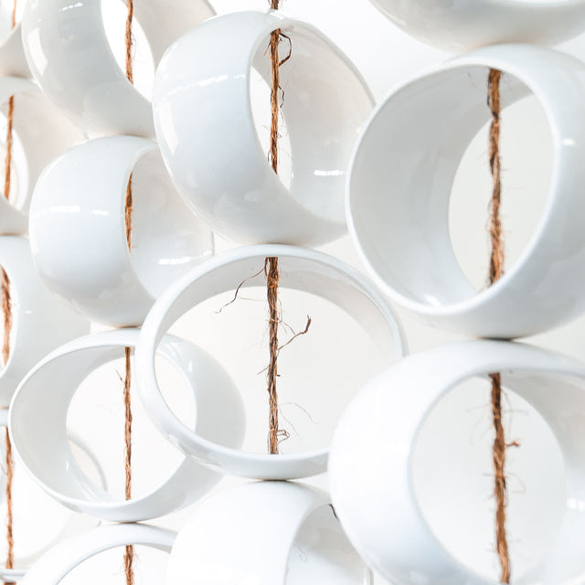 White Orb Sculpture, detail of glossy white stoneware orbs, by Jim Schatz