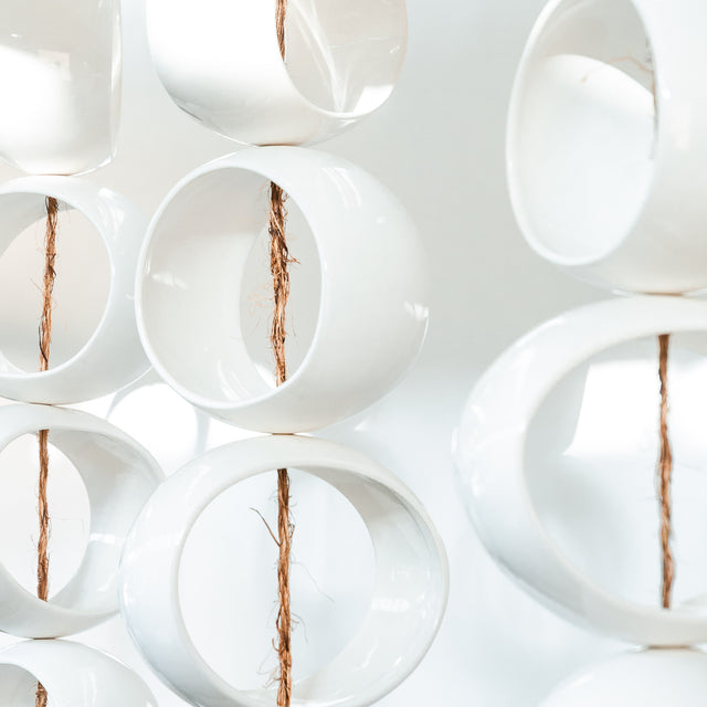 White Orb Sculpture, detail of glossy white stoneware orbs, by Jim Schatz
