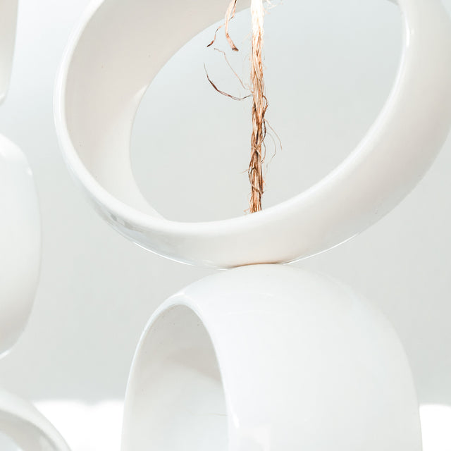 White Orb Sculpture, detail of glossy white stoneware orbs, by Jim Schatz