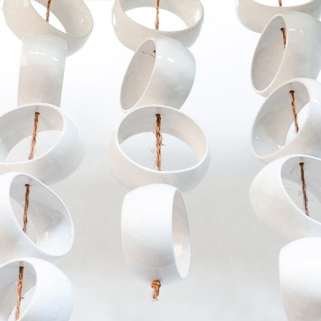 White Orb Sculpture, detail of glossy white stoneware orbs, by Jim Schatz