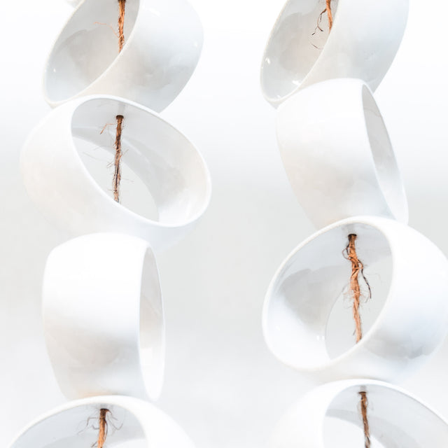 White Orb Sculpture, detail of glossy white stoneware orbs, by Jim Schatz