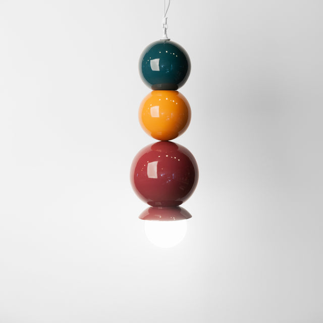 Midnight blue, ginger, and plum ceramic Dot Dot Dot pendant, J Schatz.