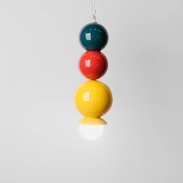 Midnight blue, sumac red, and goldenrod ceramic Dot Dot Dot pendant, J Schatz.