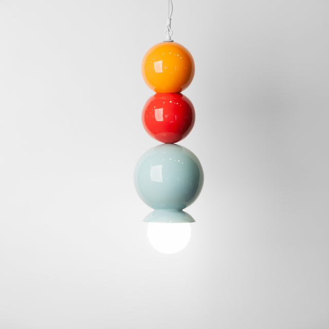 Orange peel, sumac red, and light aqua ceramic Dot Dot Dot pendant, J Schatz.