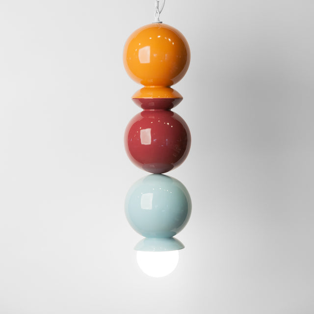 Ginger, plum, and light aqua ceramic Dot Dot Dot pendant, J Schatz.
