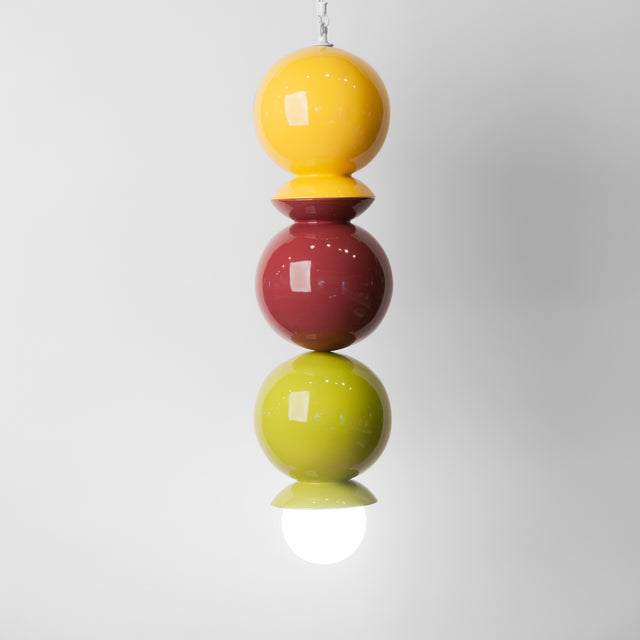 Goldenrod, plum, and olive ceramic Dot Dot Dot pendant, J Schatz.